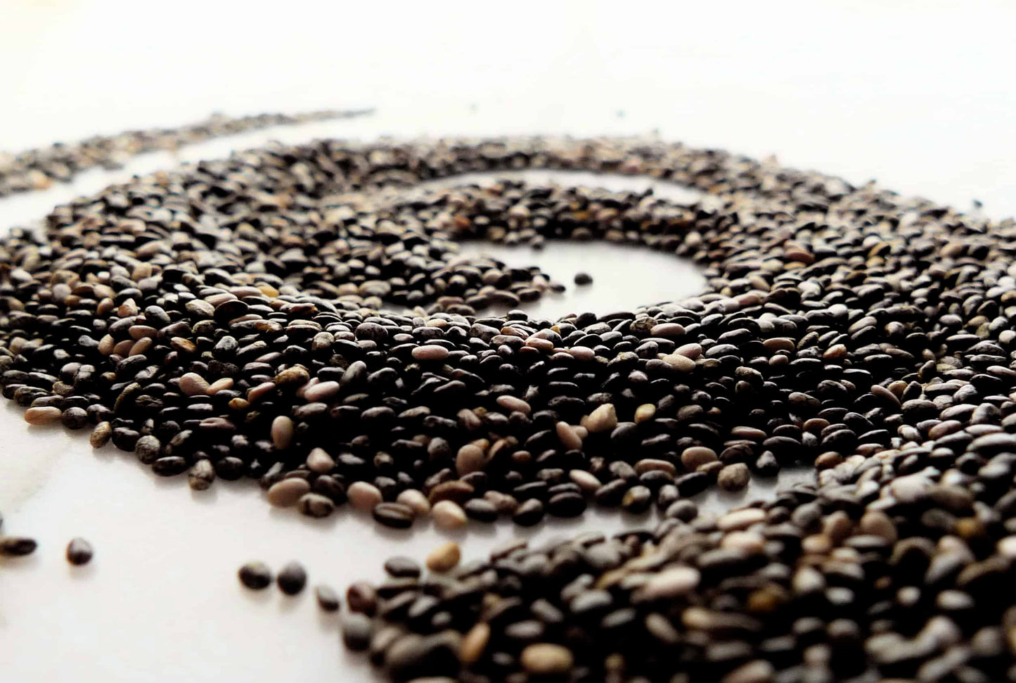 A close up shot of chia seeds in a circular pattern