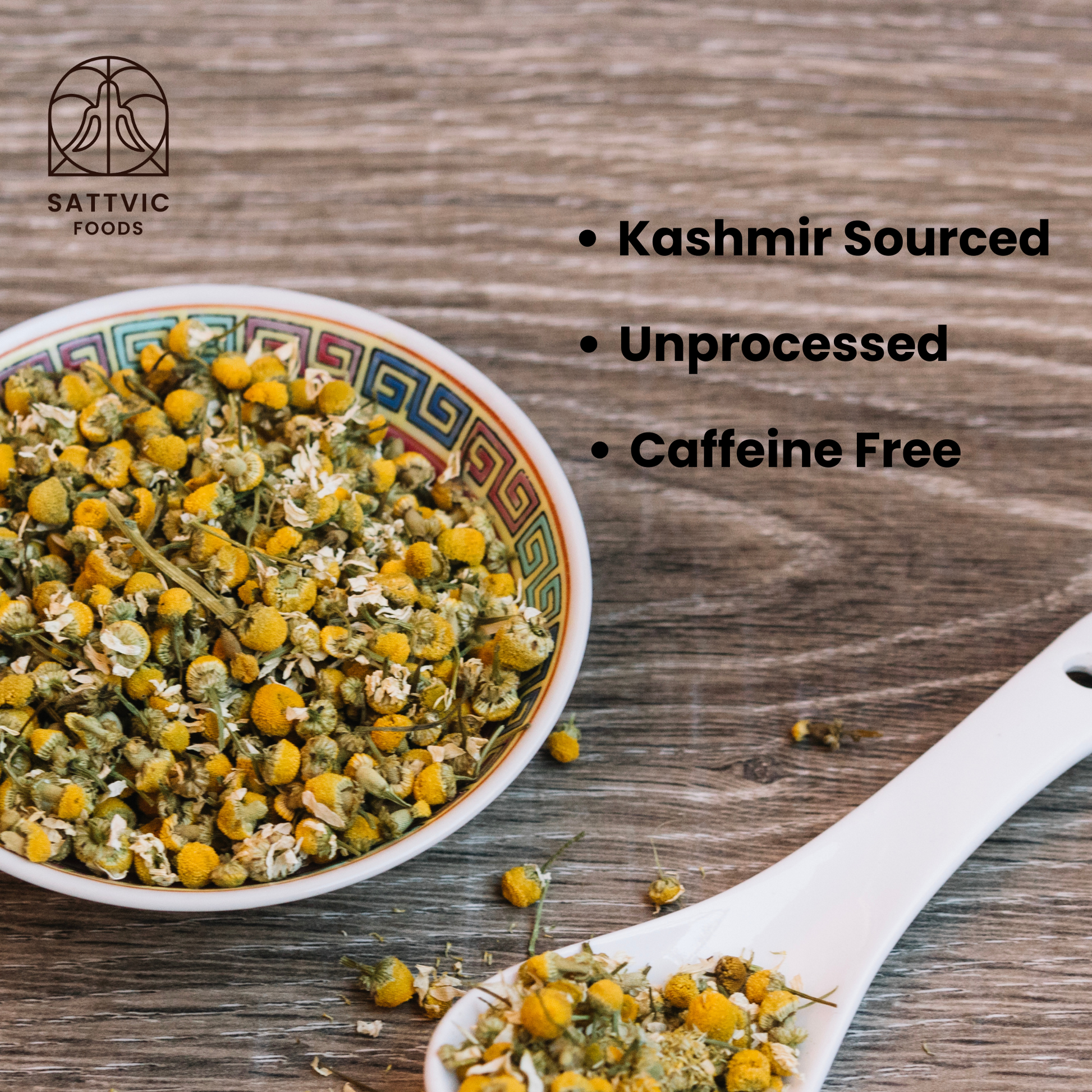 A bowl of Kashmir-sourced, unprocessed, caffeine-free chamomile tea flowers displayed on a wooden surface, showcasing its natural quality