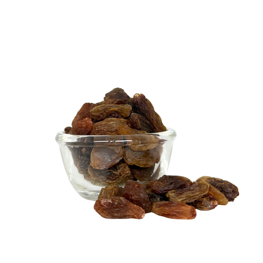 Glass bowl filled with raisins on a white background