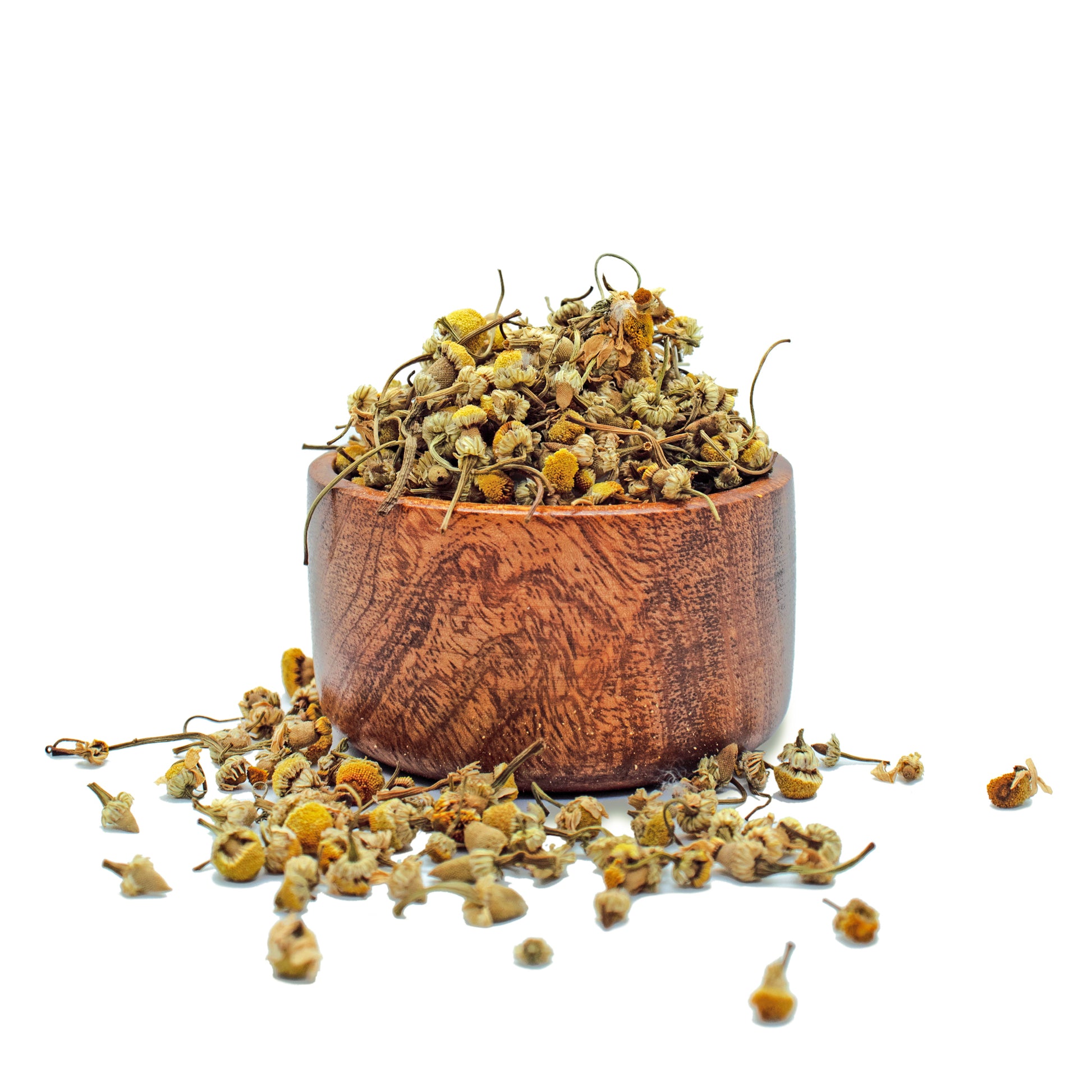 A bowl of dried loose chamomile flowers