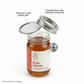 Jar of raw honey with labeled components on a white background