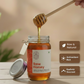 Jar of raw honey with a honey dipper, surrounded by nature-themed elements.