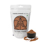 Sattvic Foods carob powder package with a scoop of powder on a white background