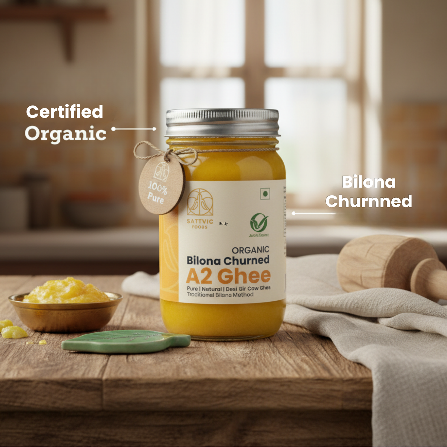 Jar of Organic Bilana Churned A2 Ghee on a wooden surface with a blurred kitchen background.
