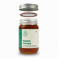 Jar of Neem Honey with a green label on a white background