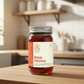 Jar of raw honey on a kitchen counter with a blurred background