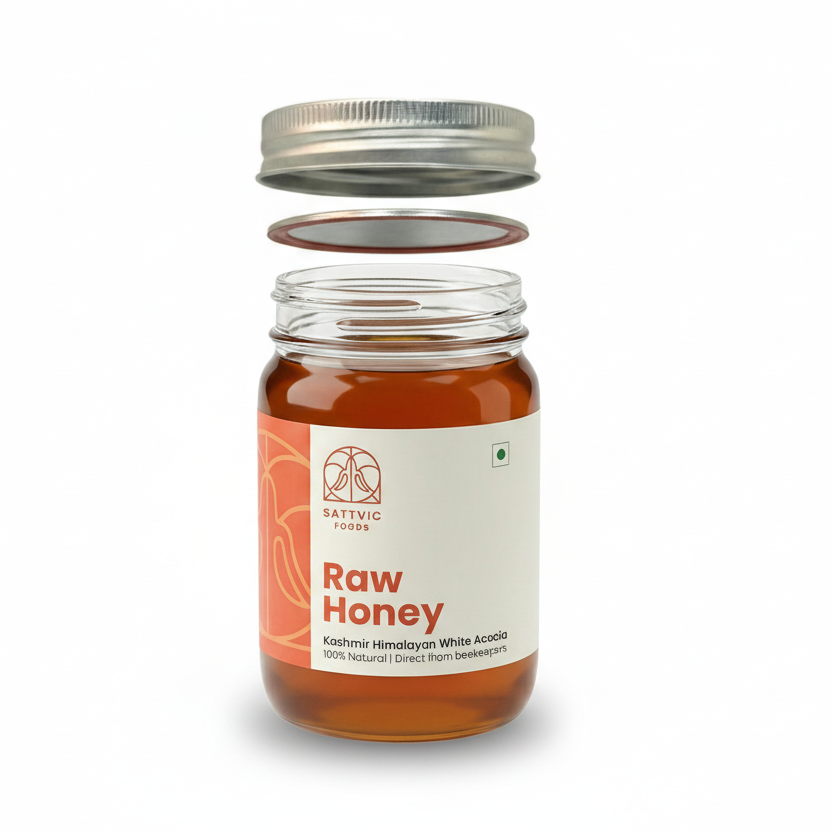 Jar of raw honey with a white label on a white background