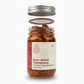 Jar of sun-dried tomatoes with a visible label on a white background